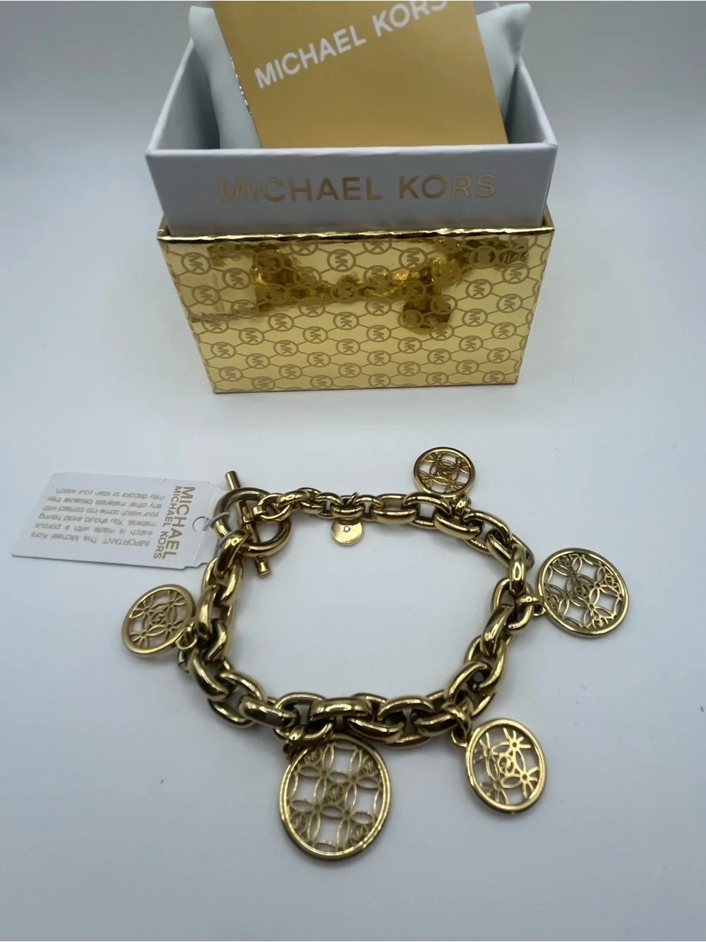 Michael Kors Gold Tone Charm Toggle Bracelet MK Logo Medallion NWT in Box